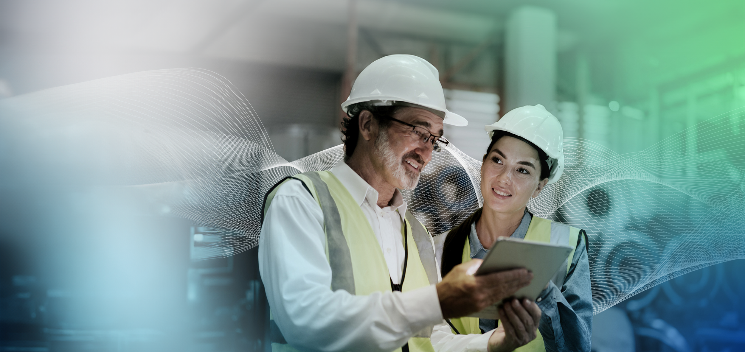 two workers in high vis and hard hats use synergi life software
