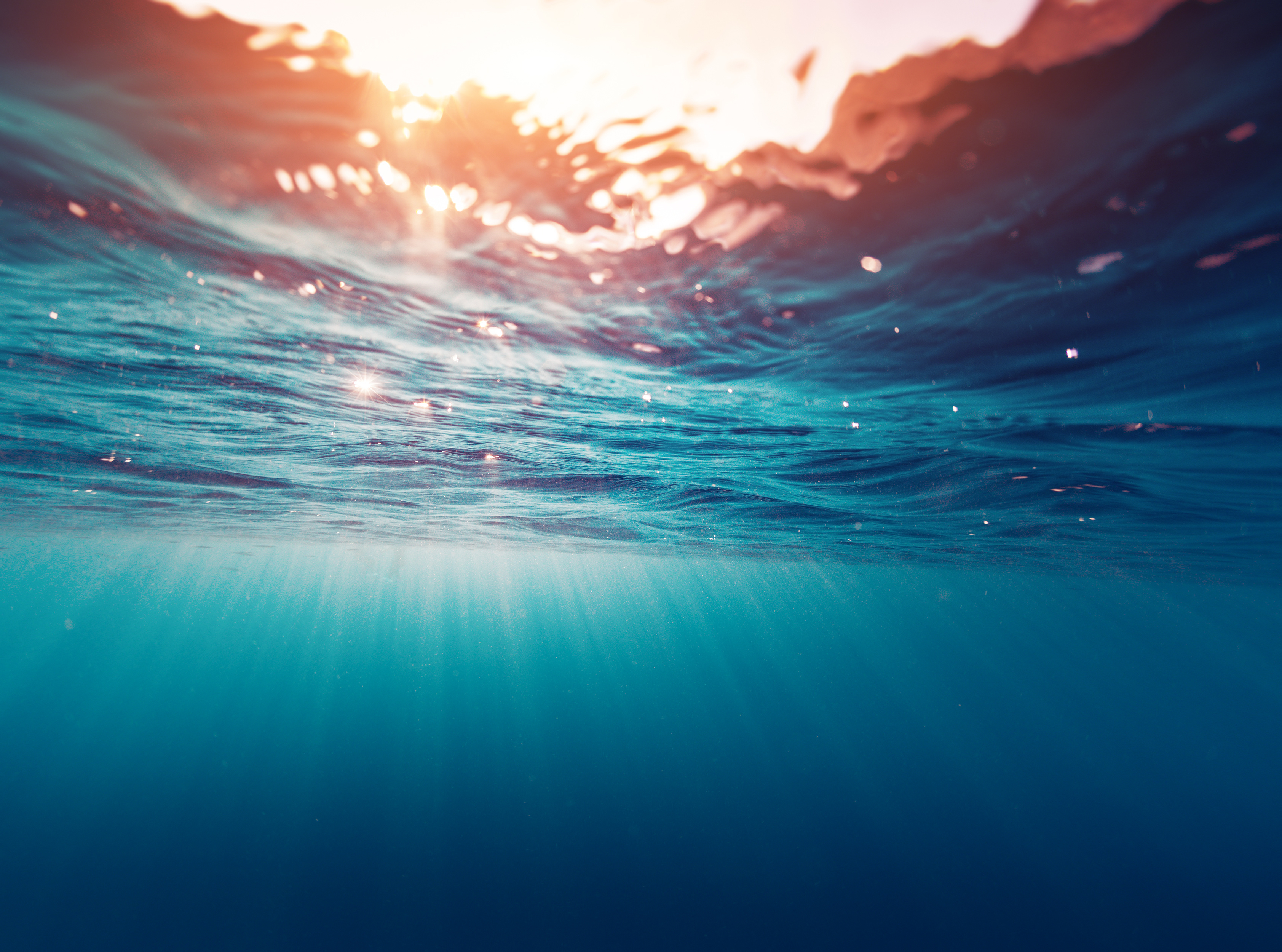 Underwater view with sunlight beams representing ocean environmental assessments and site modelling