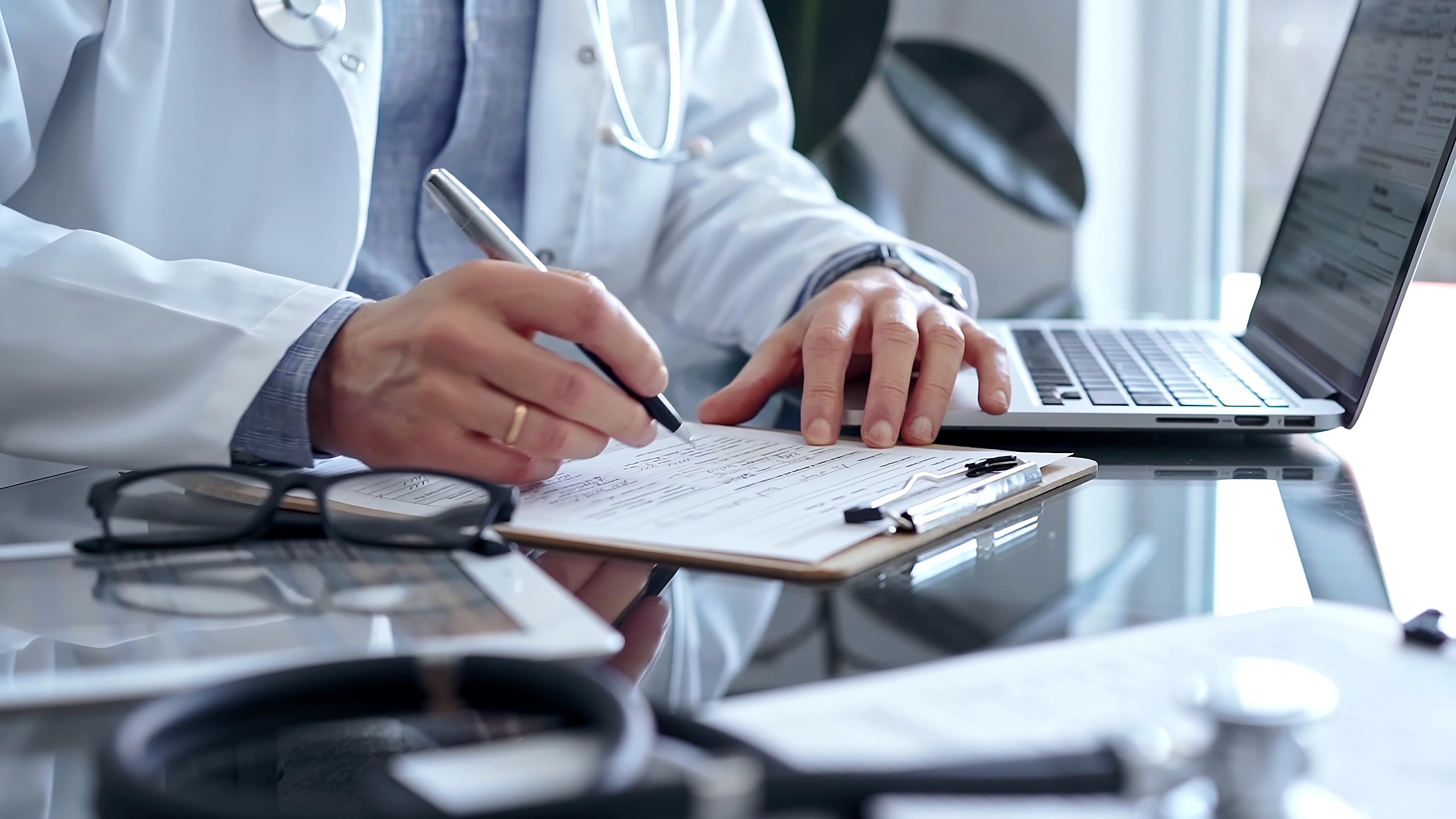Healthcare professional reviewing regulatory documentation with a stethoscope, representing DNV’s expertise in UKCA conformity assessment and compliance