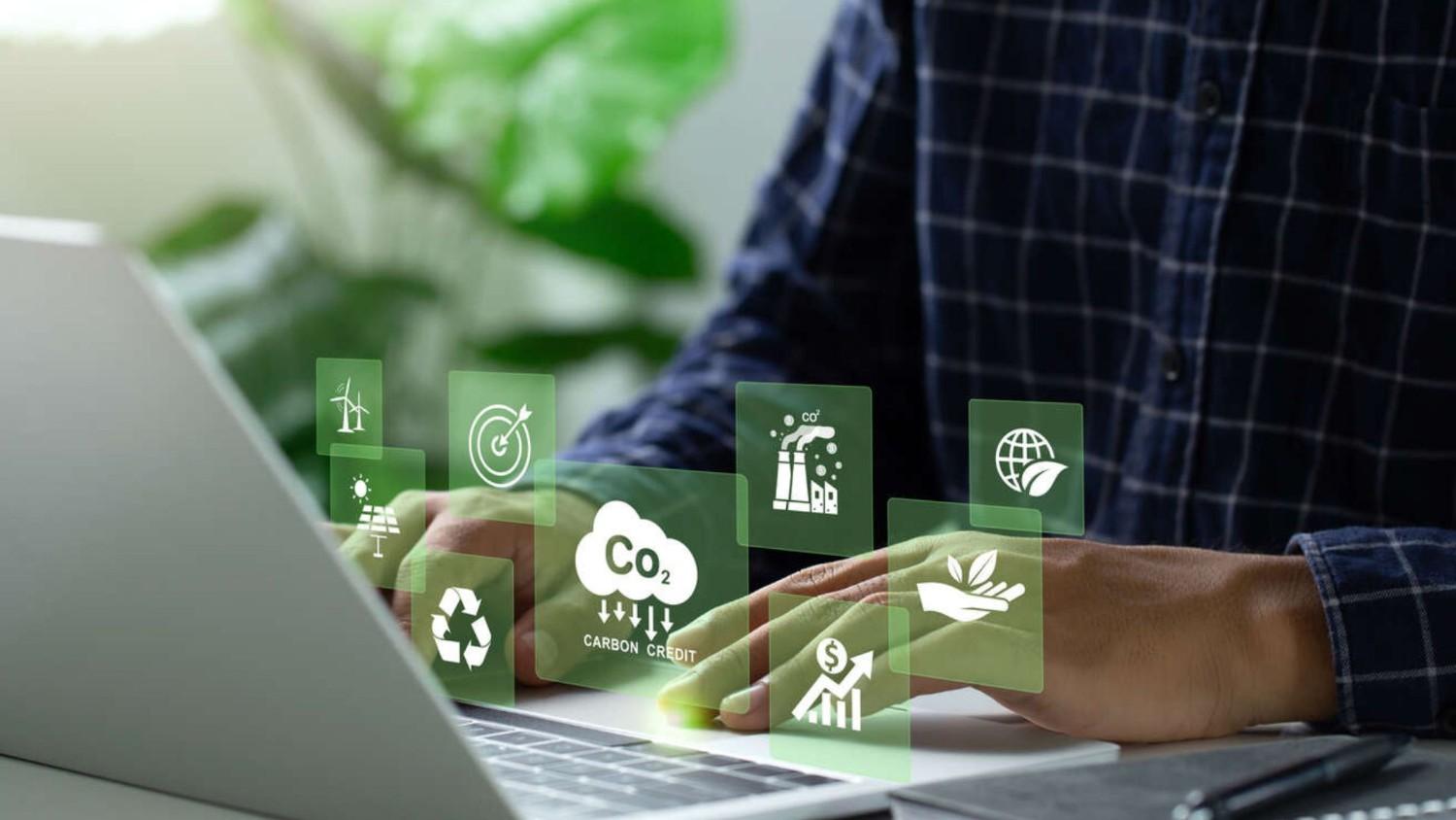 Using a laptop to trade carbon credit on a virtual screen