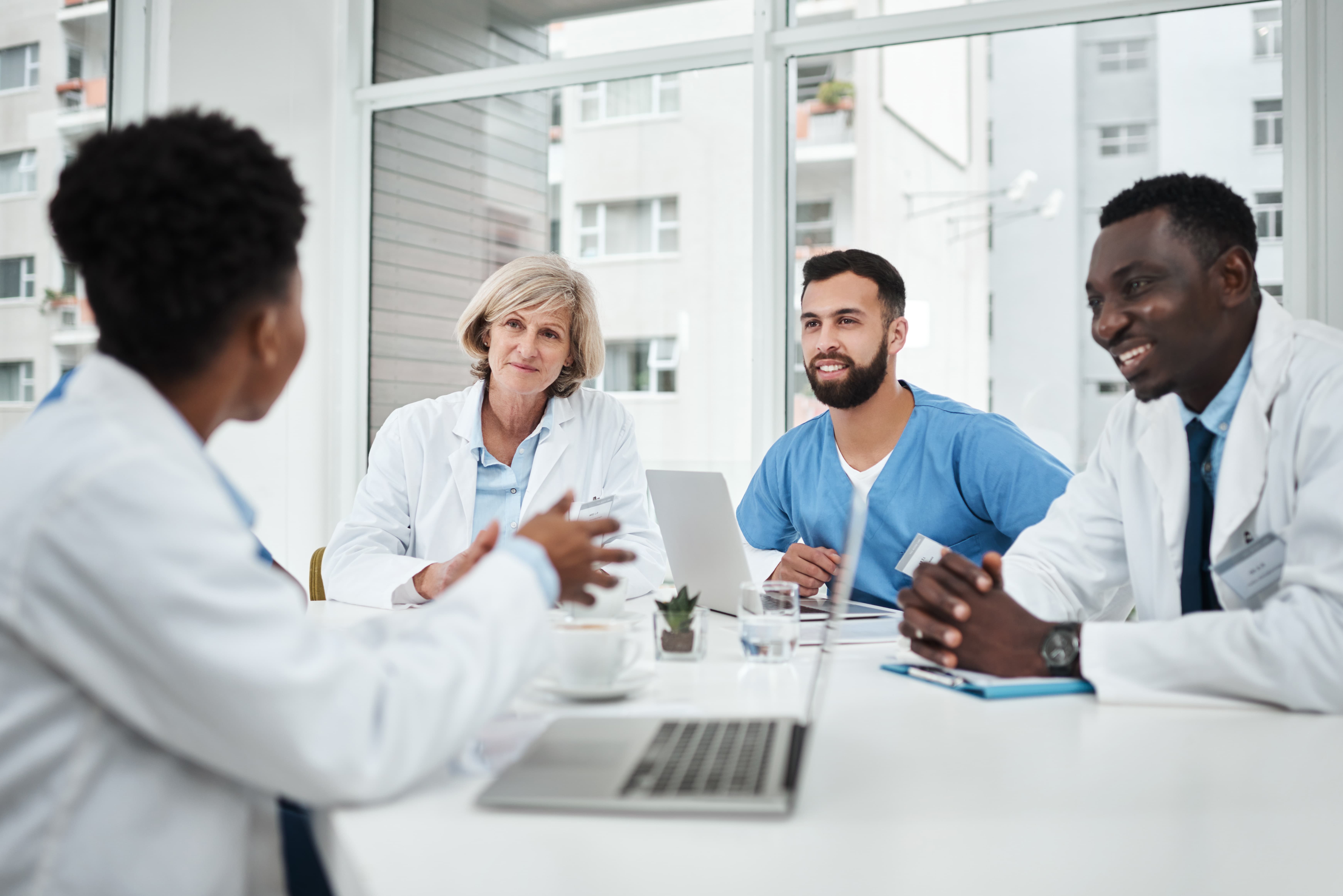 four healthcare workers in conversation
