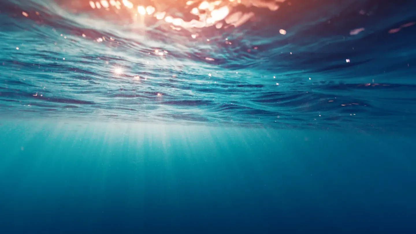 Underwater view with sunlight beams representing ocean environmental assessments and site modelling