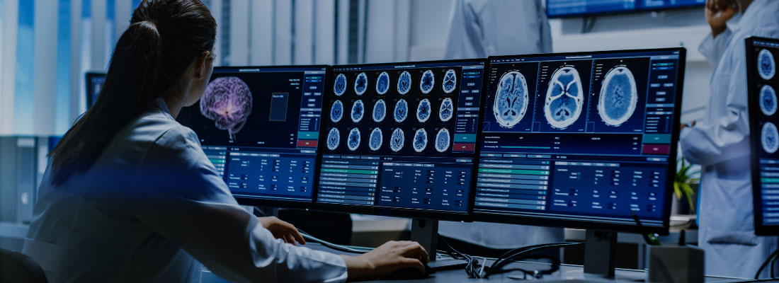 Neurologists reviewing digital brain scans on large monitors in a hospital command center, representing DNV’s stroke certification programs focused on quality and patient outcomes